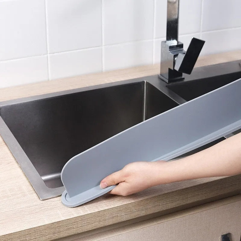 Grey-blue silicone kitchen sink water blocking plate measuring 52mm by 85mm