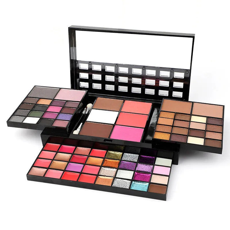 Open 74 colour makeup combination palette showing four layers of eyeshadow, lip gloss, blush and contour powders with brushes.