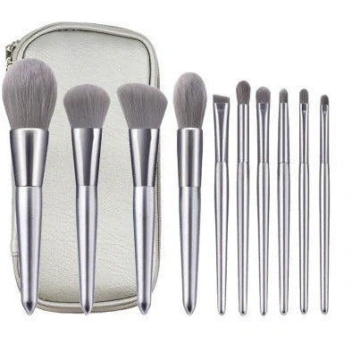 10 makeup brushes with moonlight silver finish and wooden handles beside PU brush bag