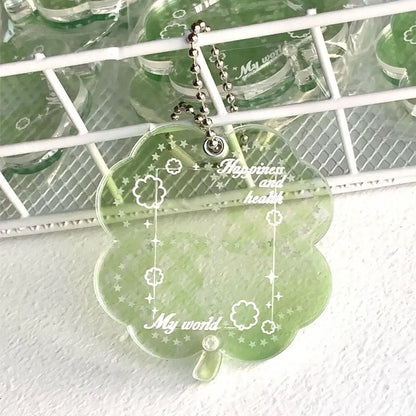 Four-leaf clover shaped acrylic phone pendant keychain in blue, green, and mint colour options