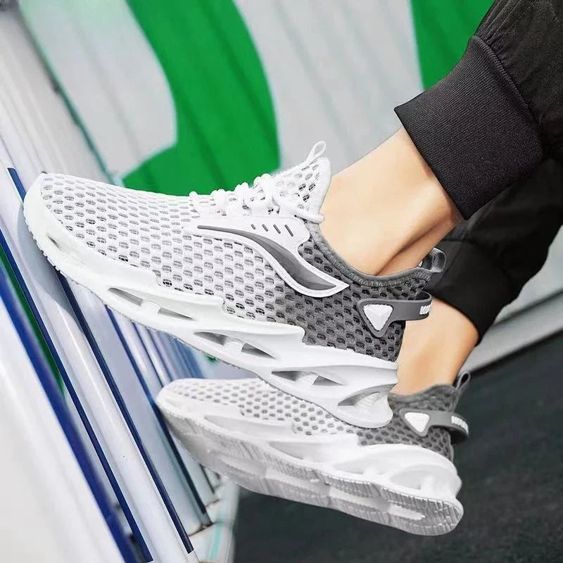Breathable mesh running shoes with lace-up closure, available in black, white blue, and white grey colors
