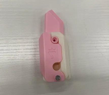 3D printed plastic carrot fidget knife with retractable blade, shown in orange and green colour scheme.