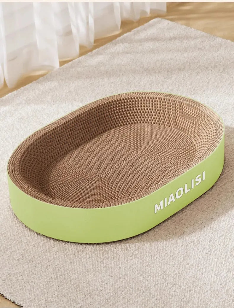 Green oval corrugated paper cat scratch board and nest bed measuring 55cm diameter