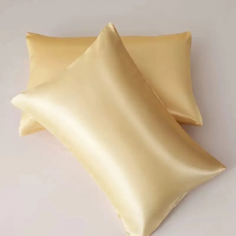 Pair of solid colour satin pillowcases showing smooth plain weave texture and reactive dye colour