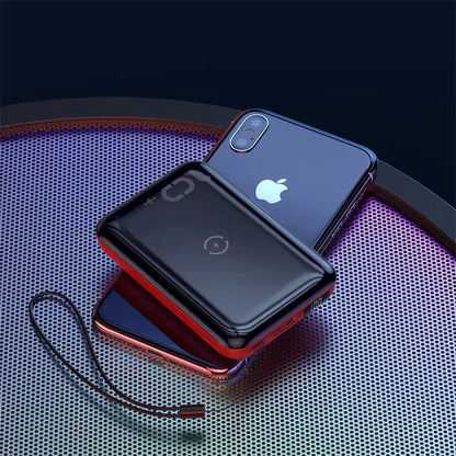 Small square black wireless charging power bank with LED display showing battery percentage.