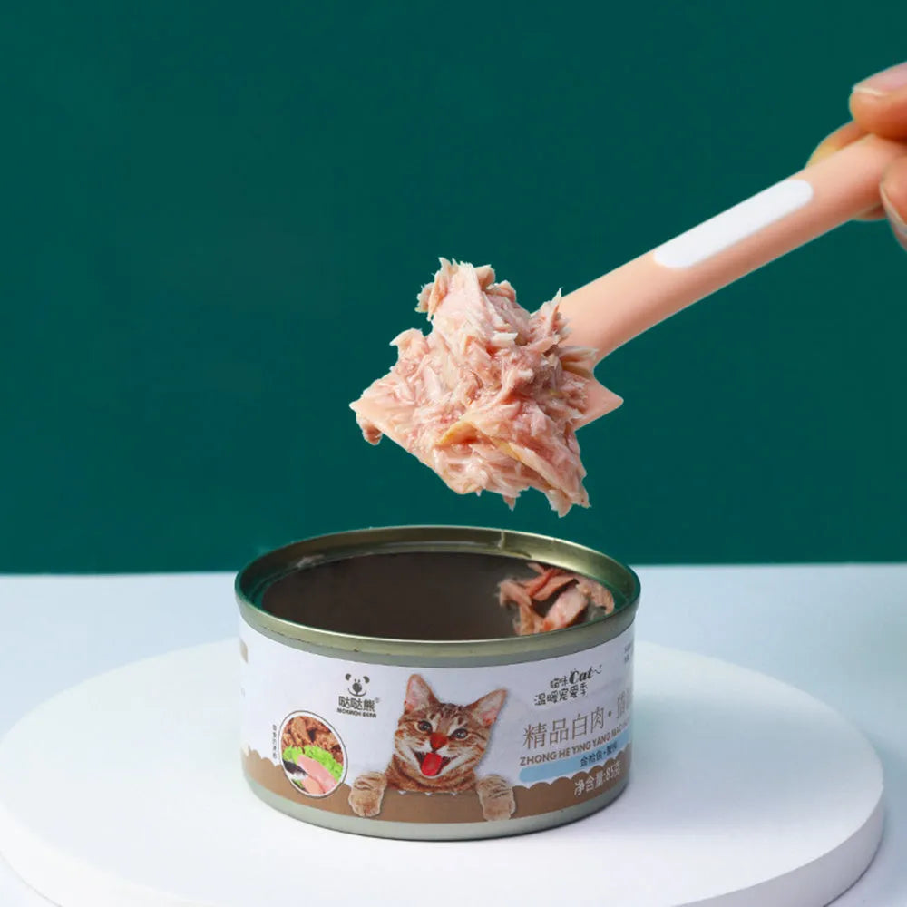 Green long-handle pet feeding spoon with right-angle head for scraping canned wet food.