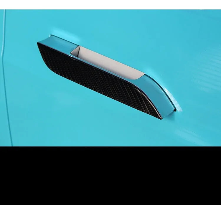 Set of four carbon fibre texture adhesive door handle protectors for Tesla Model S interior.