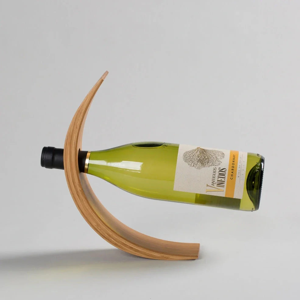 Natural bamboo wine bottle rack holding six bottles with wood grain visible