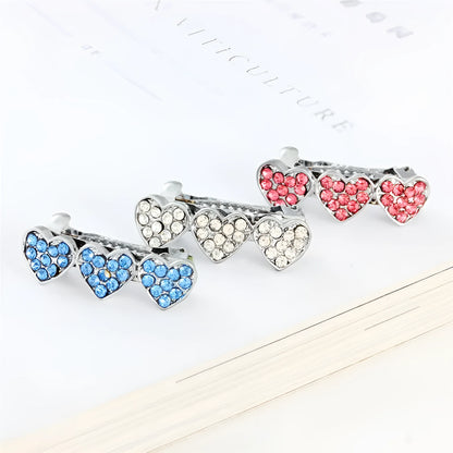 A 3cm long peach heart shaped hair clip with rhinestones and a small dog charm, on a white background.
