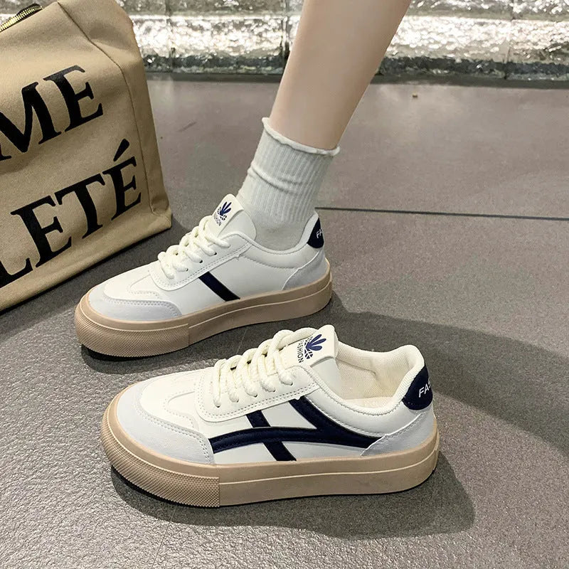 Low-top blue and brown casual lace-up shoes with round toe and flat rubber sole.