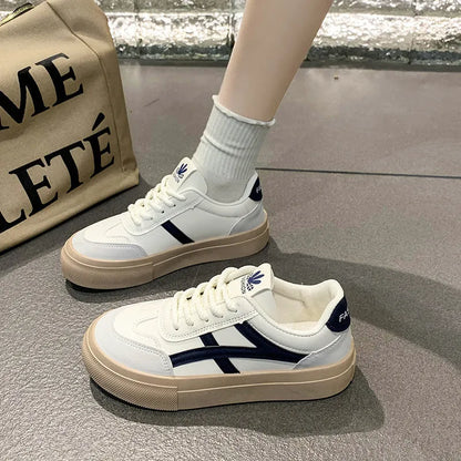 Low-top blue and brown casual lace-up shoes with round toe and flat rubber sole.