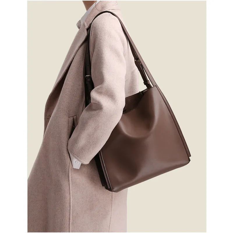 Genuine leather women's commuter bag large capacity first layer cowhide soft bucket style handbag with double shoulder straps European American retro design in black or brown colour with polyester lining and multiple internal compartments