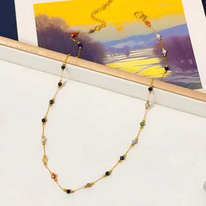 Gold electroplated titanium steel necklace for women with a natural stone pendant on an O-ring chain.