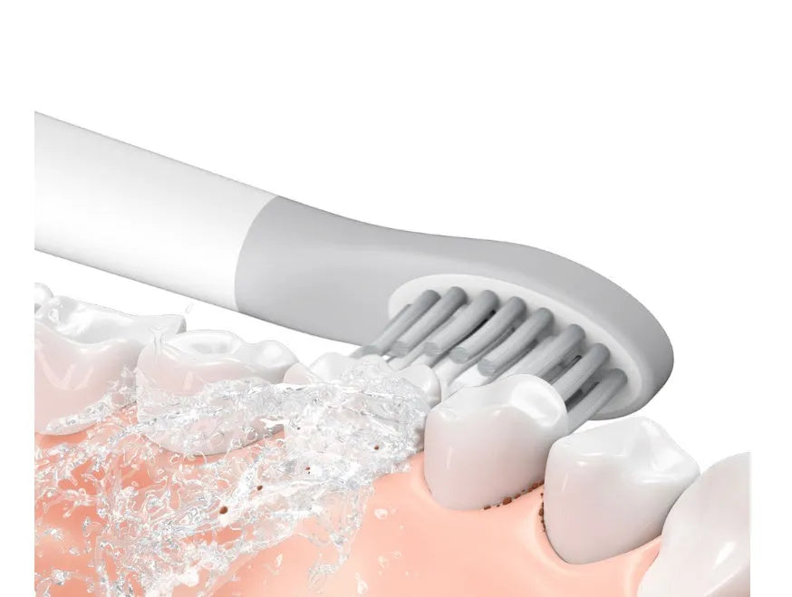 SOOCAS sonic electric toothbrush in blue or pink with round brush head on a bathroom counter.