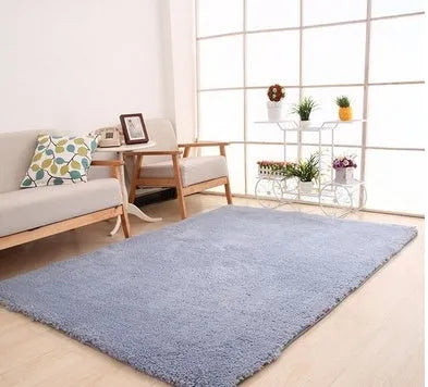 Solid colour plush rectangle area rug with soft texture on a wooden floor.
