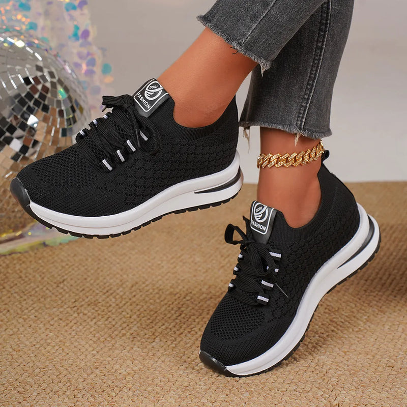 Women's flat heel lace-up mesh sneakers in black or white with round toe and shallow cut design for casual wear, available in EU sizes 35 to 43, featuring a lightweight mesh upper and rubber injection moulded sole