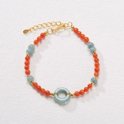 Natural South Red Agate women's bracelet with safety buckle on a wrist, showing geometric beads and auspicious patterns.