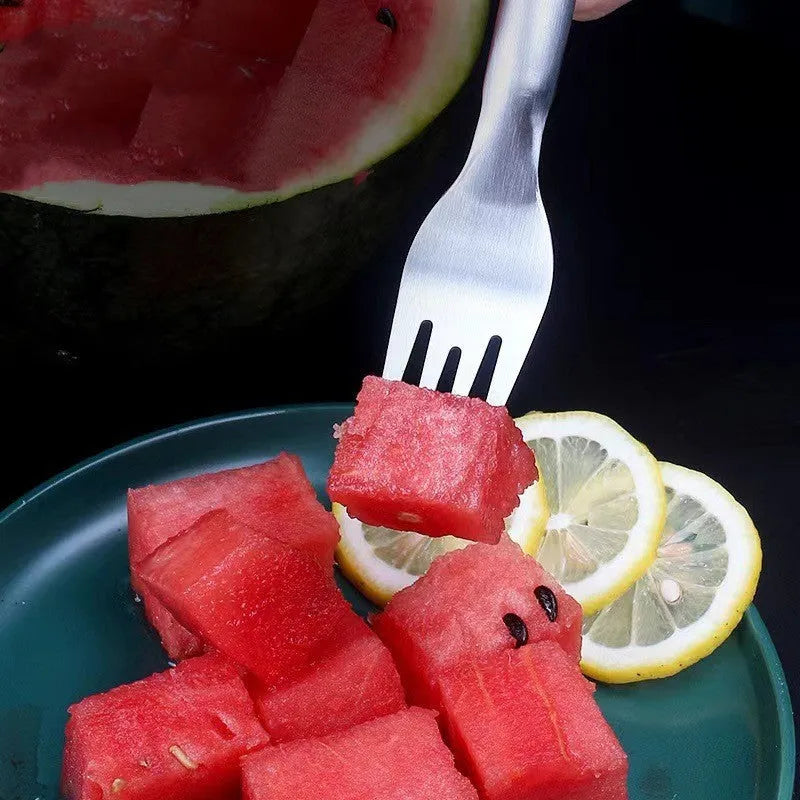 Stainless steel watermelon slicer and serving fork on a kitchen counter.