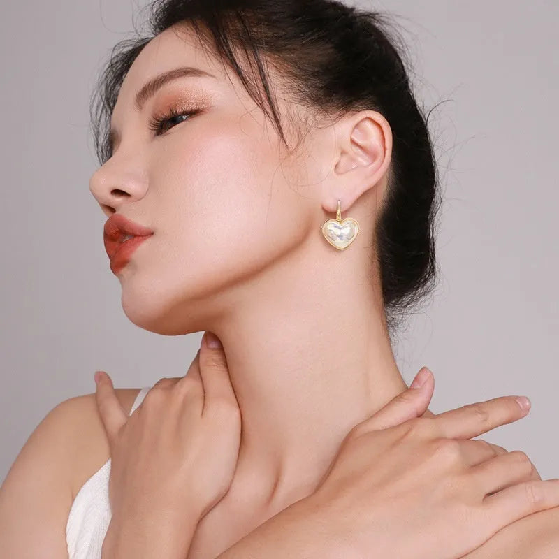 Gold-coloured alloy clip-on earring for women with a natural design.