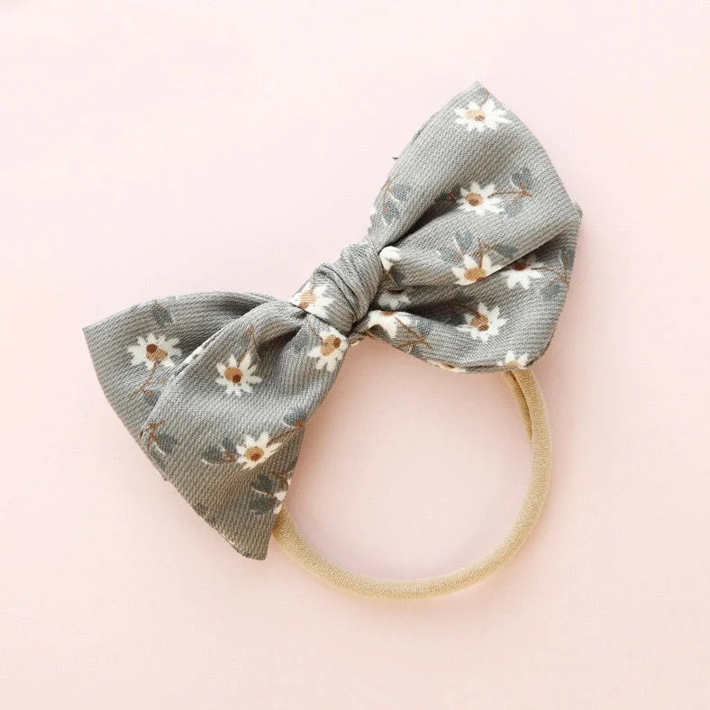 Children's cloth hair band with knotted bow design in one of six colour options