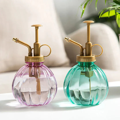 A stylish garden sprayer in a pumpkin shape with a retro-inspired copper pressure bar, designed for watering flowers and plants efficiently.