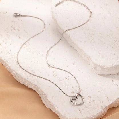 Elegant titanium steel heart pendant necklace with adjustable chain in gold and silver colors
