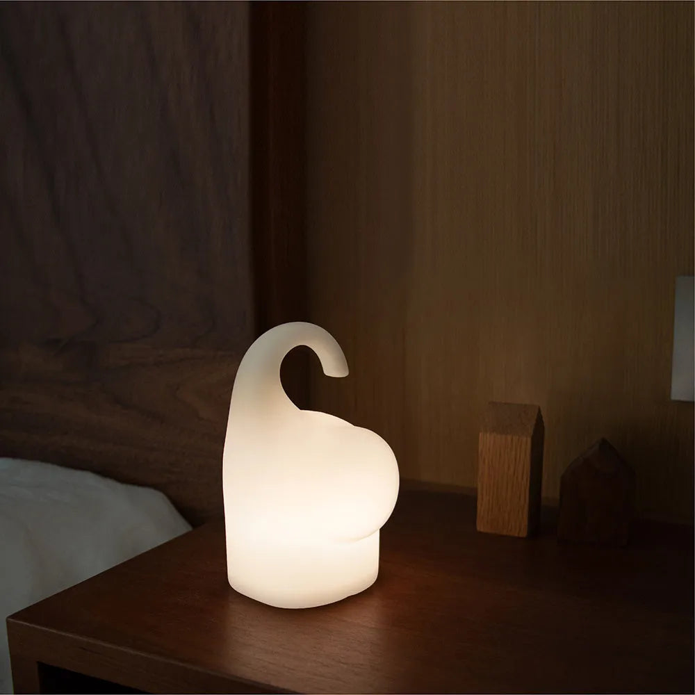 White elephant-shaped night light with silicone texture, 96mm wide by 151mm tall, emitting warm white glow