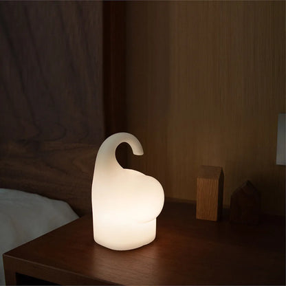 White elephant-shaped night light with silicone texture, 96mm wide by 151mm tall, emitting warm white glow
