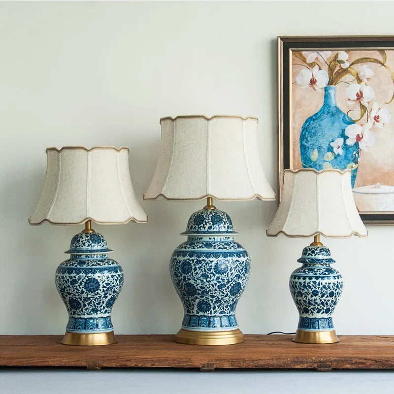 Chinese blue and white porcelain table lamp with cloth shade on bedside table