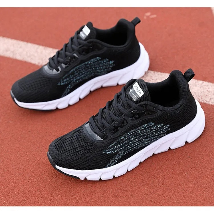 Women's black and white low-top casual running sneakers with round toe and MD soles