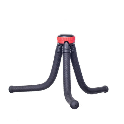 Black octopus tripod with flexible rubber legs wrapped around a pole, holding a smartphone.