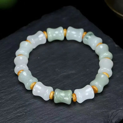 Simple Korean-style bracelet with natural chalcedony and coconut shell beads on an elastic string, showing the diamond-shaped safety lock.