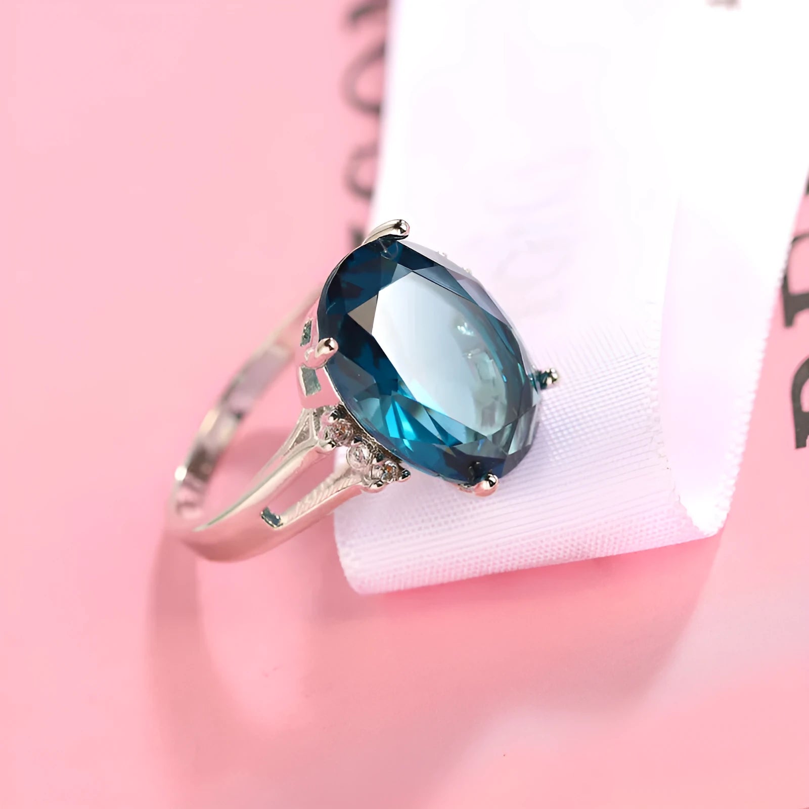 Blue black geometric ellipse shaped copper ring with an electroplated finish on a hand.