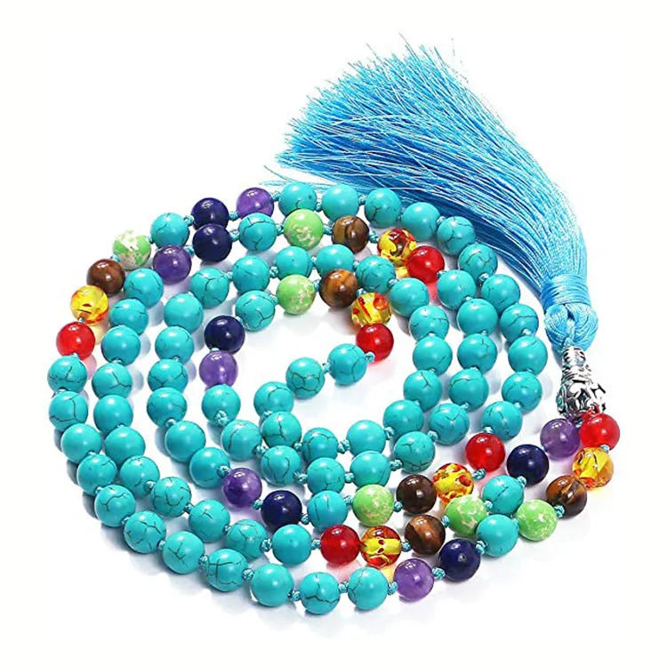 Long multi-coloured agate and stone tassel necklace with geometric beads on a white background.