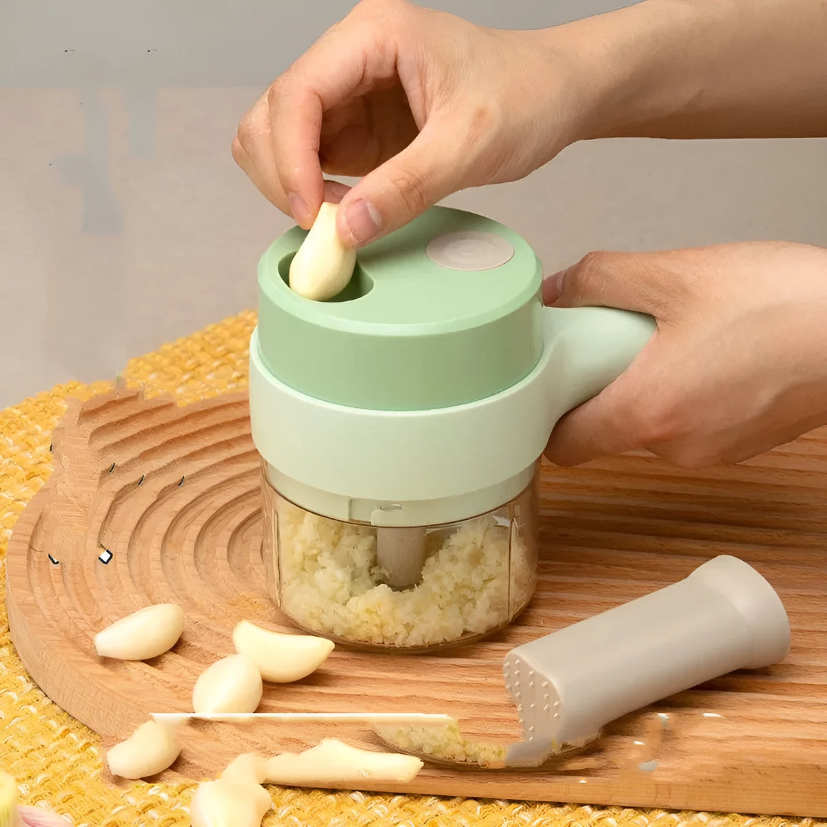 Wireless electric garlic masher and slicer combo, plastic body, 18.5cm x 13.1cm x 9.38cm, with Type-C cable and manual.