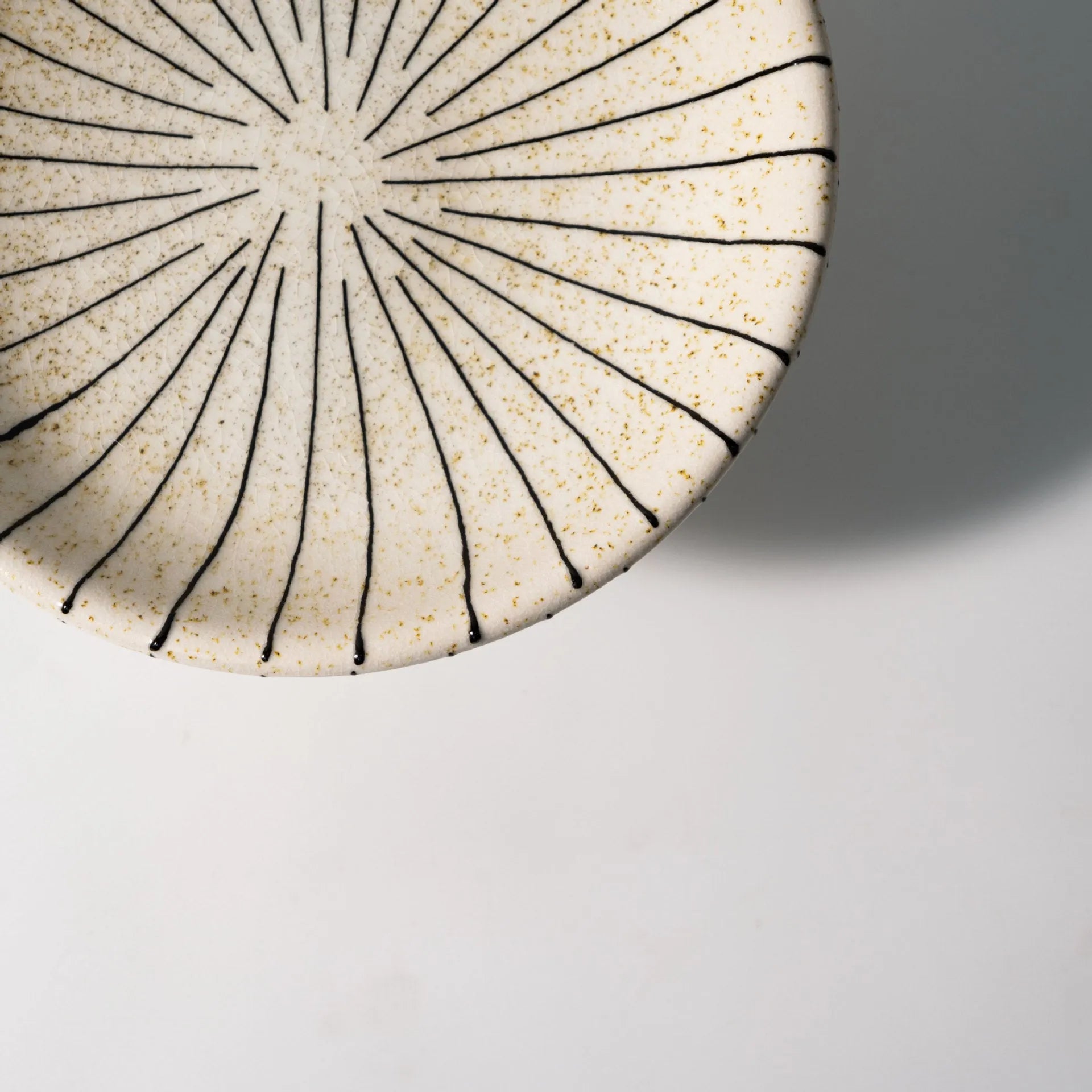 Black and white striped synthetic resin fruit plate with retro fruit motifs, 20cm diameter