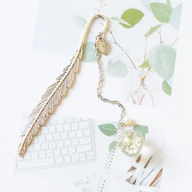 Dried flower bookmark with alloy frame measuring 12cm by 2cm, showing preserved botanical specimens