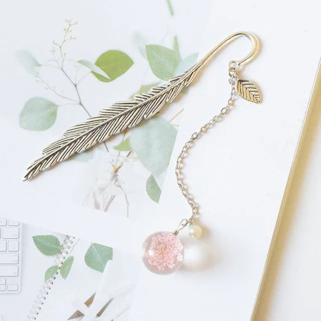 Dried flower bookmark with alloy frame measuring 12cm by 2cm, showing preserved botanical specimens