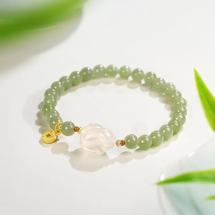 Handmade women's bracelet with a glass rabbit charm on a coloured glaze chain.