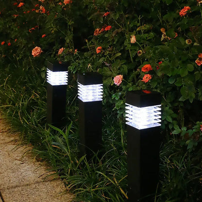 A tall, cuboid-shaped white solar lawn lamp standing in a garden.