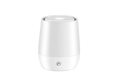 White USB aroma diffuser with simulated flame lighting effect on a wooden surface.