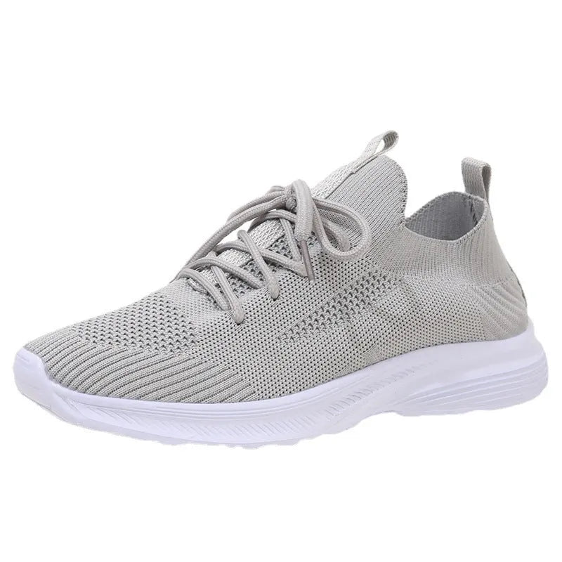 Women's Flyknit mesh running shoes in milky white with a low flat heel and rubber sole