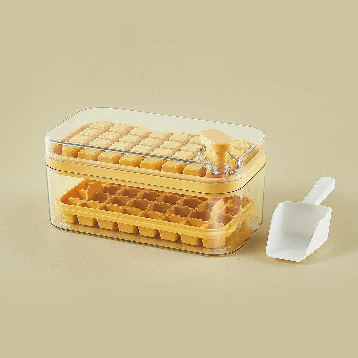Green one-button press ice mould box with storage lid and ice shovel on kitchen counter