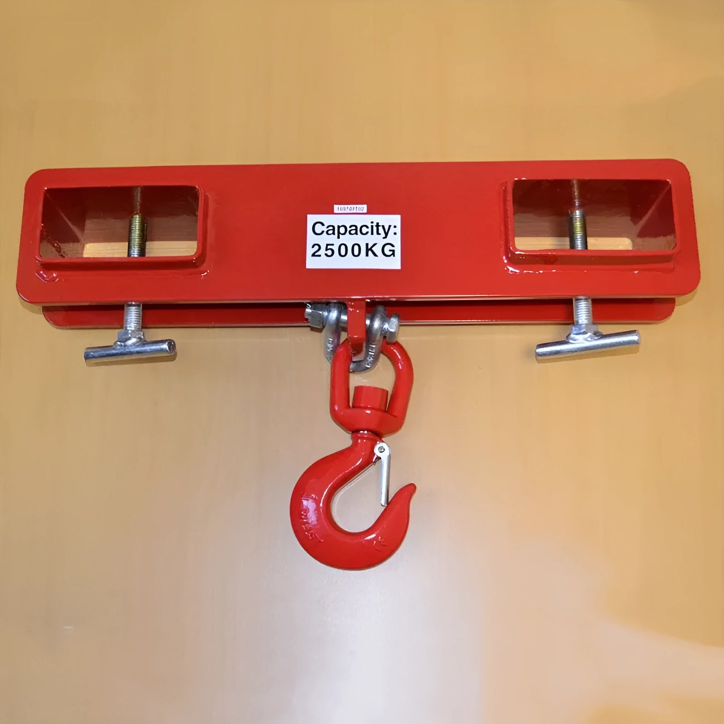 Heavy-duty iron forklift hook with rotatable drum and safety locking latch, shown mounted on forklift forks.