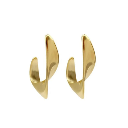 A pair of gold twisted geometric metal earrings with a round detail on a white background.