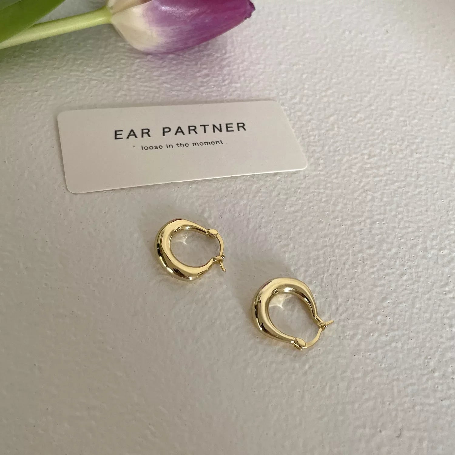 Small fat circle ear clip bracelet in white gold and yellow gold colours