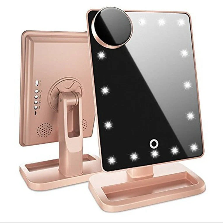 Pink touch screen makeup mirror with LED lights and Bluetooth speaker showing 10X magnification section