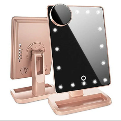 Pink touch screen makeup mirror with LED lights and Bluetooth speaker showing 10X magnification section