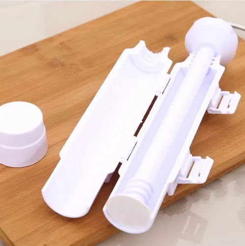 White plastic sushi roll mould kitchen tool on a kitchen counter.