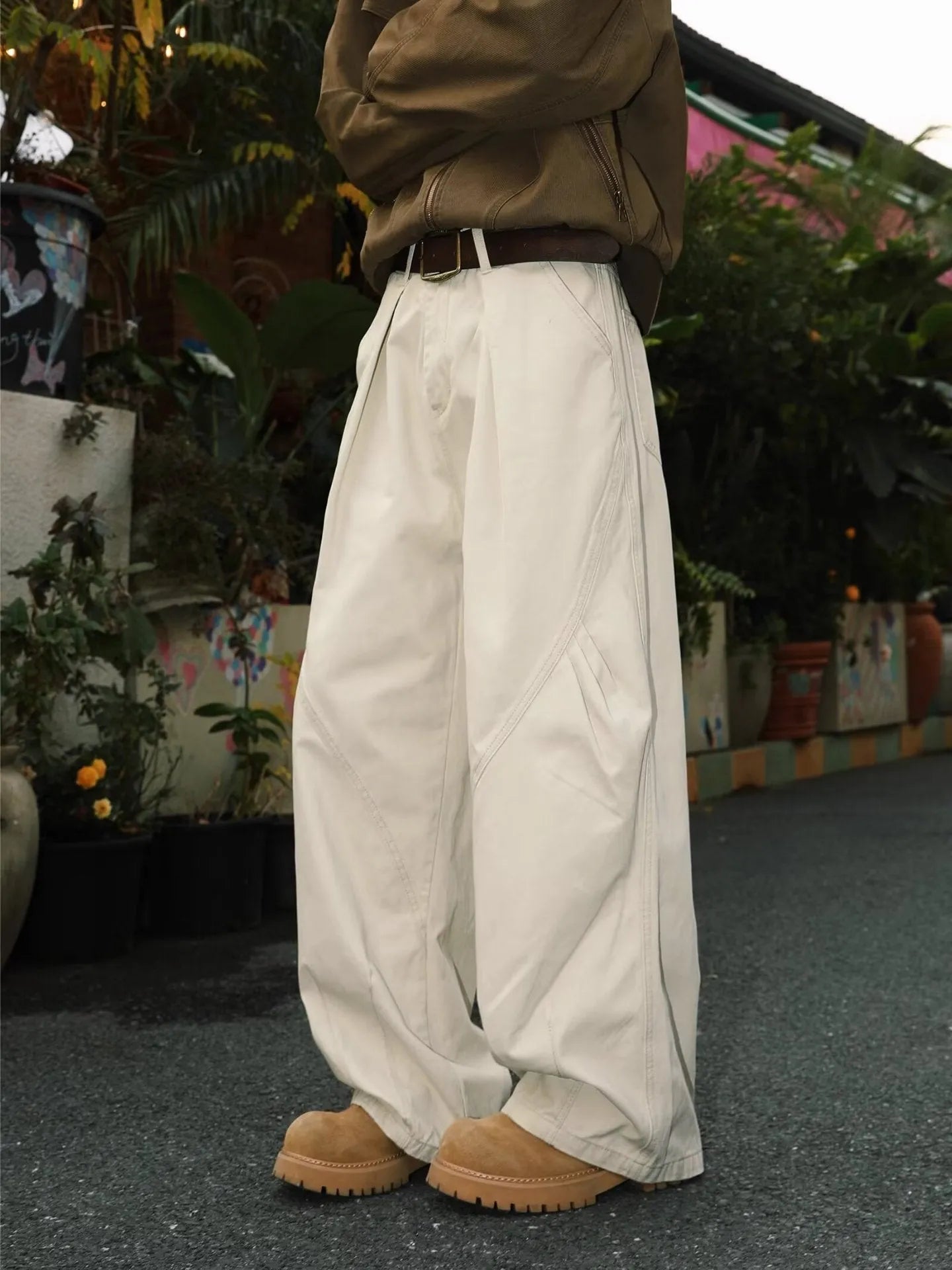 Man wearing pleated straight-leg trousers in a striped pattern with a micro elastic mid waist.